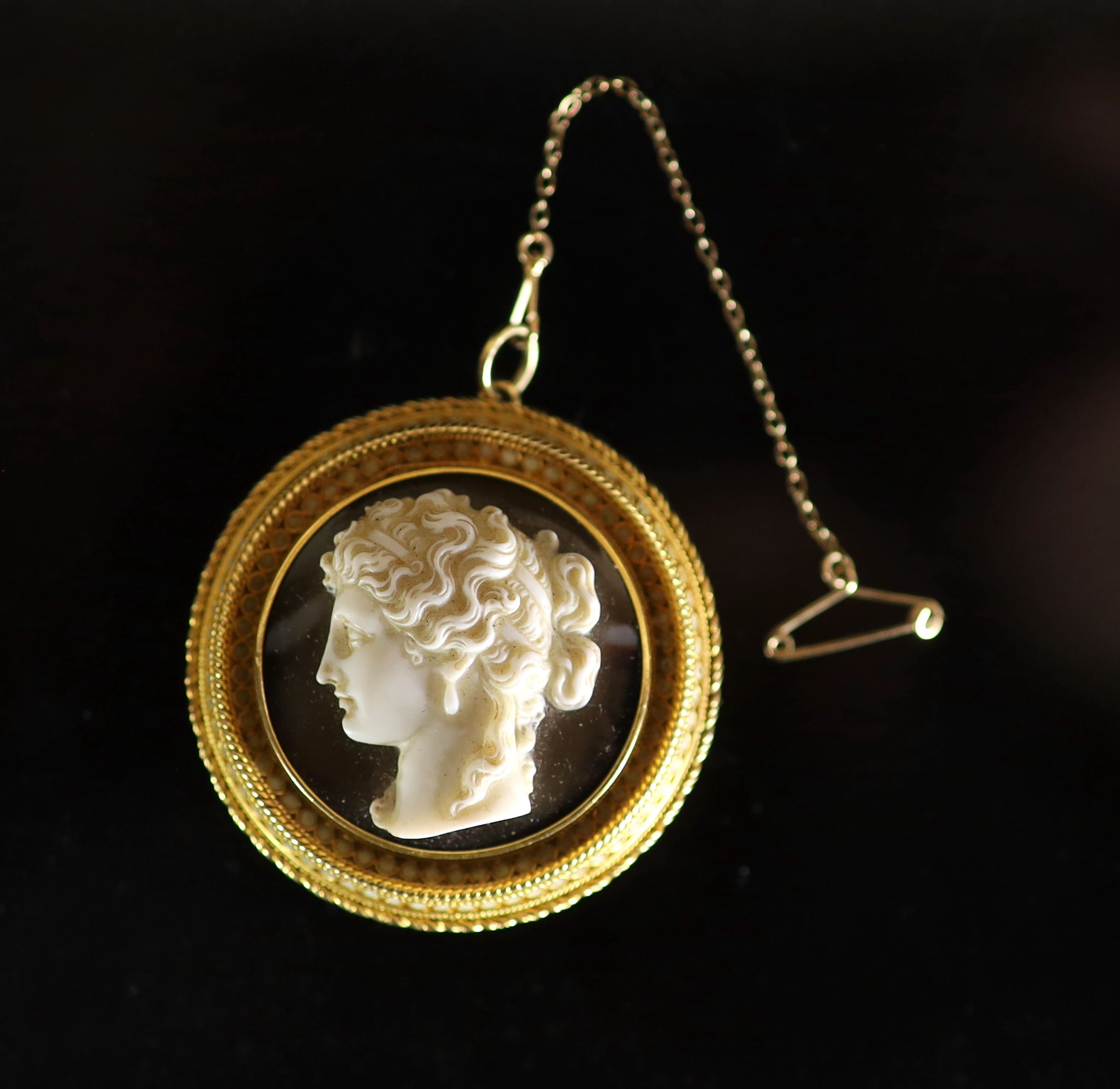 A Victorian gold and white enamel mounted agate cameo circular pendant brooch